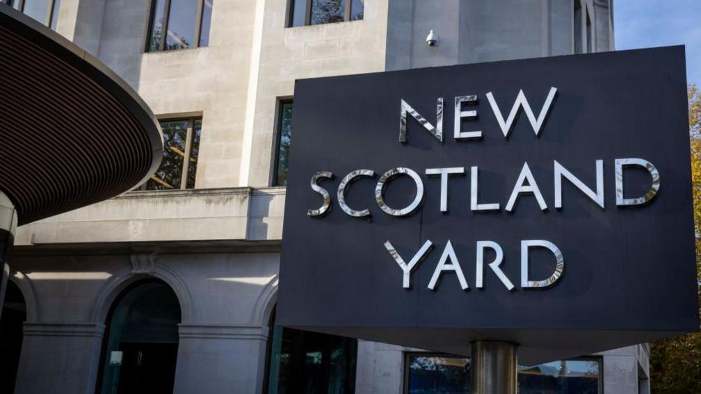 A photo of the sign outside the Met headquarters that reads: "New Scotland Yard".