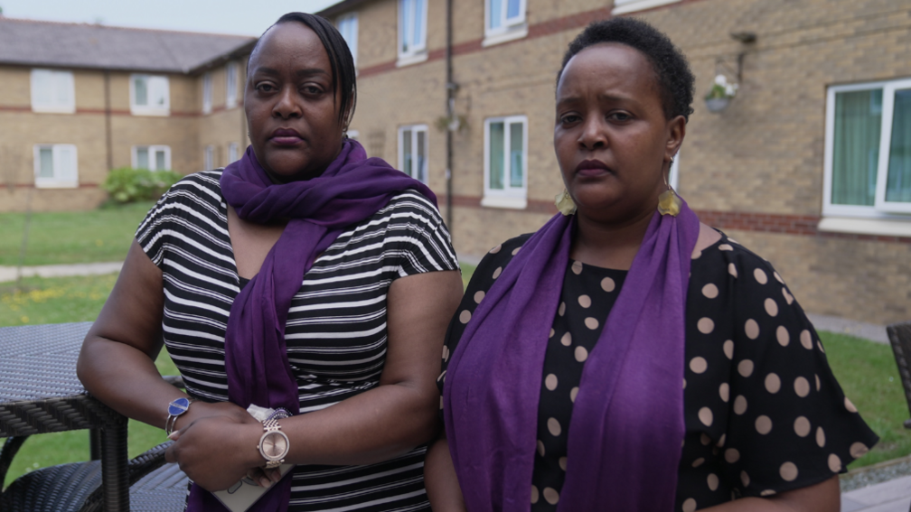 Jade Morris and Irene Muthemba outside a housing block