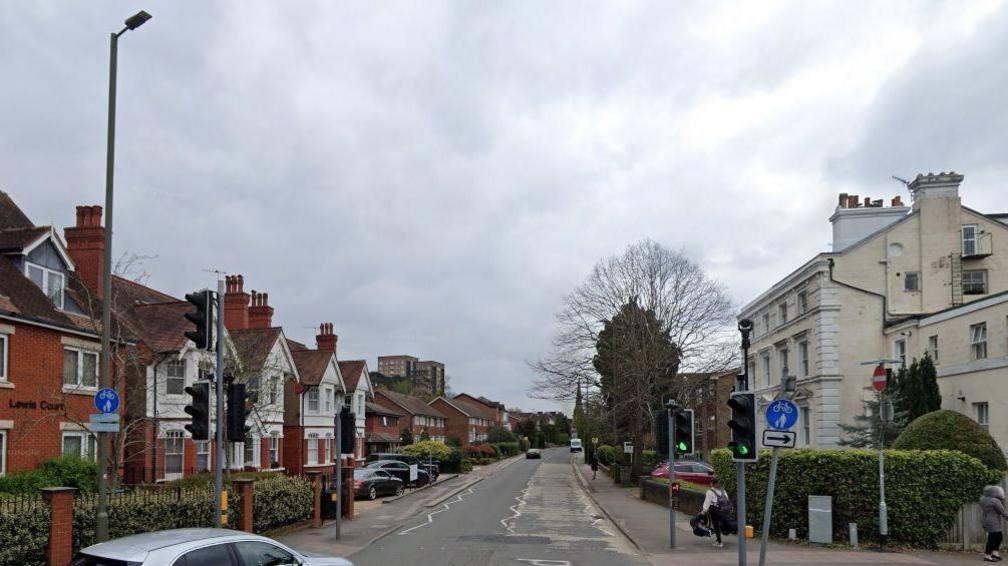 Station Road, Redhill with houses on either side and traffic lights at the end of the road