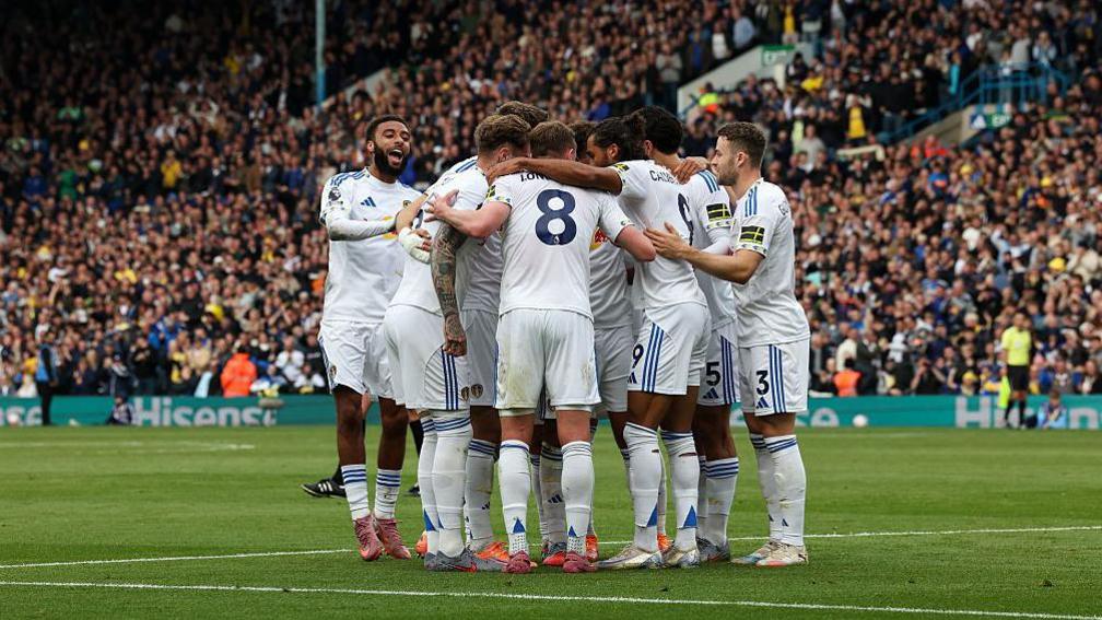 Leeds players huddle to celebrate