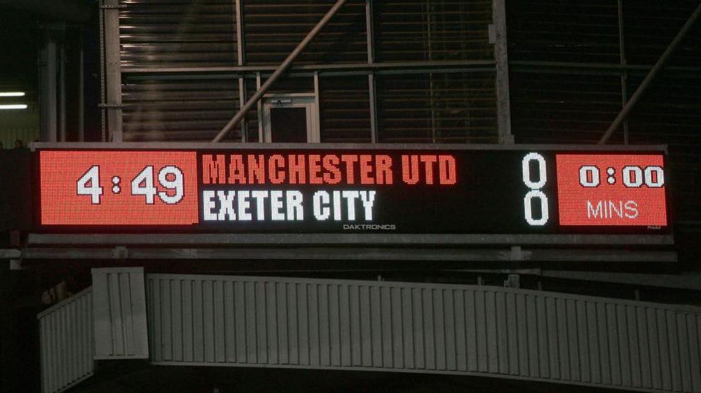 The scoreboard at Old Trafford in January 2005 showing Manchester United 0-0 Exeter City