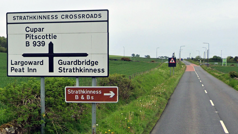 Road sign and an empty road