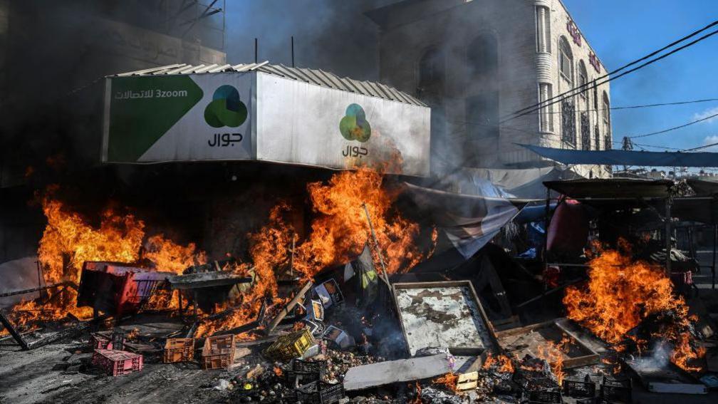 A fire breaks out in a market in the West Bank city of Jenin amid ongoing Israeli raids on 31 August 2024.