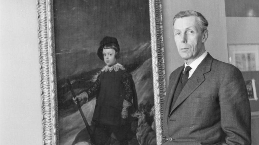 Anthony Blunt, British art historian and Surveyor of the Queen's Pictures, with a painting by Velazquez