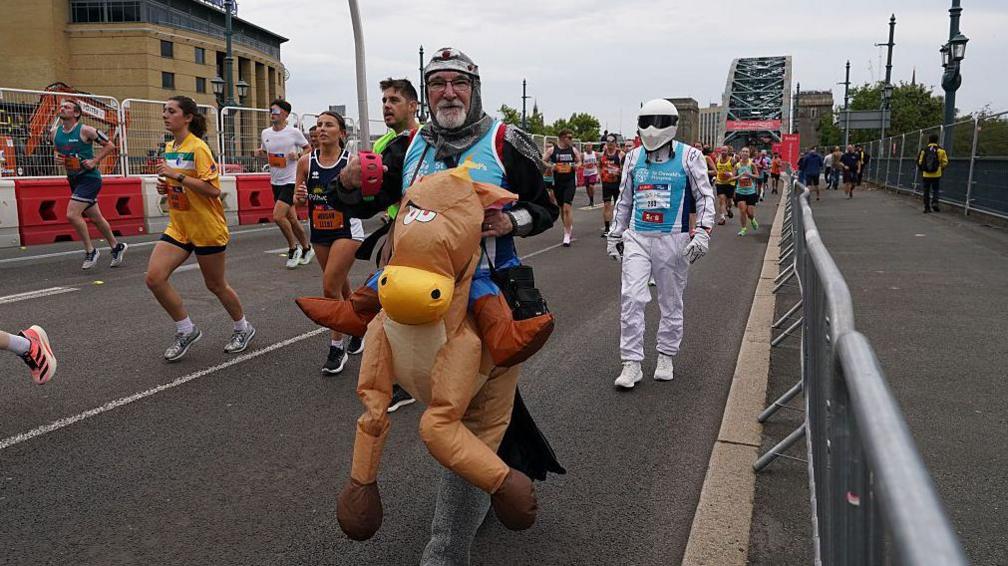 a man dressed up as a knight on a horse running.