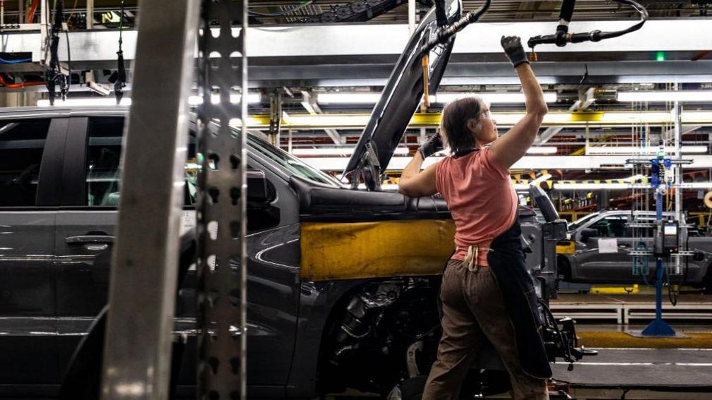 A worker installs an engine at the General Motors assembly plant in Fort Wayne, Indiana, US, on Tuesday, April 9, 2024.