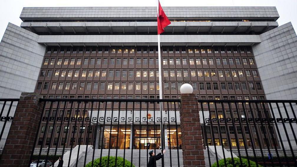 The Chinese national flag is raised in front of a court in China.