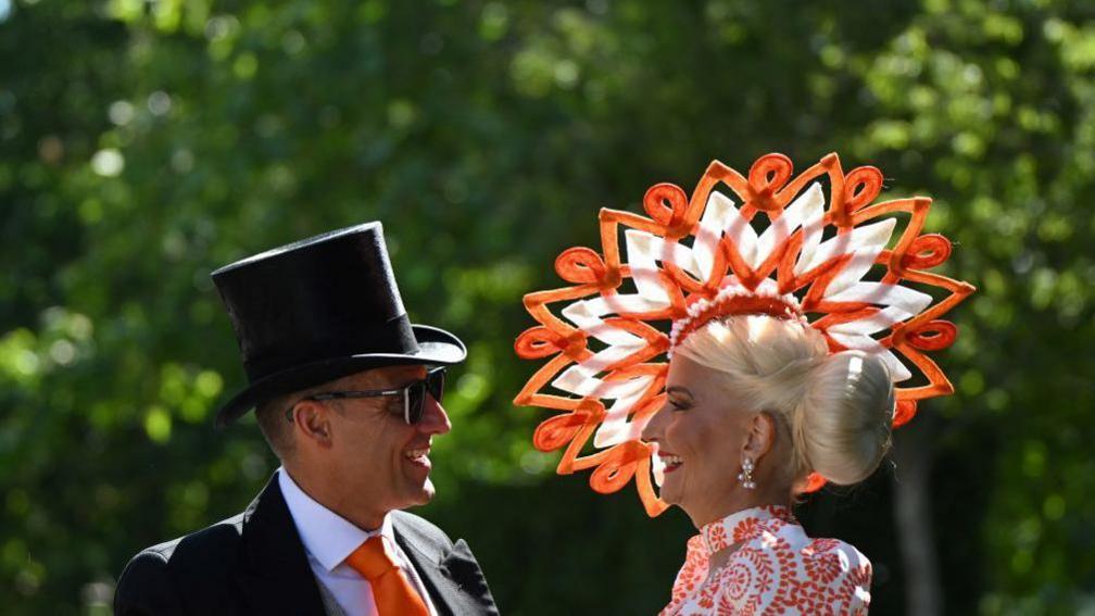 woman wearing colourful fascinator