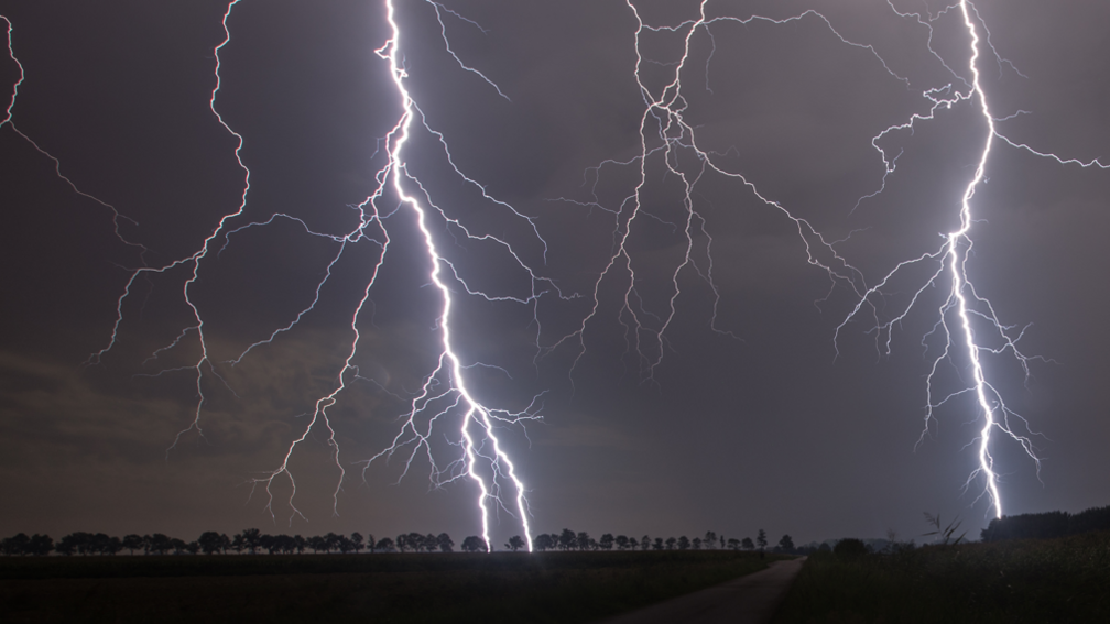 Lightening striking in dark in countryside