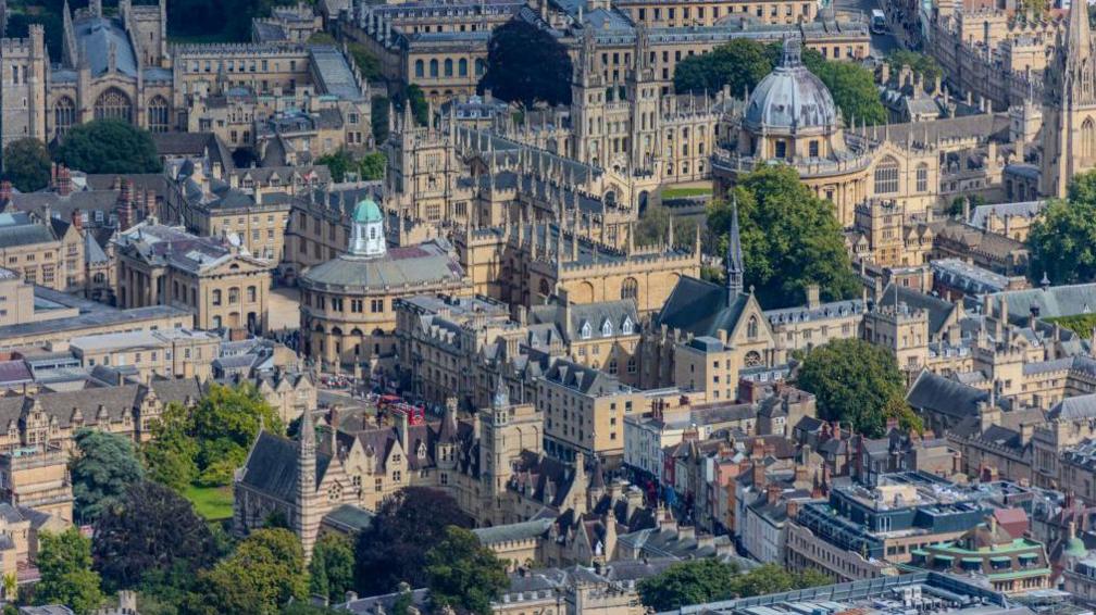 An aerial view of Oxford, mainly of university buildings, including the Sheldonian Theatre and Radcliffe Camera.