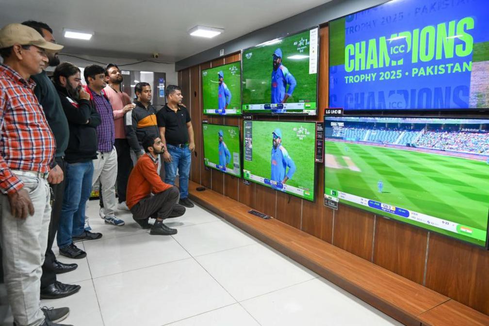 People gathered at a TV shop in Sector 18 to watch the India-Pakistan match of ICC Champions Trophy 2025, on February 23, 2025 in Noida, India.