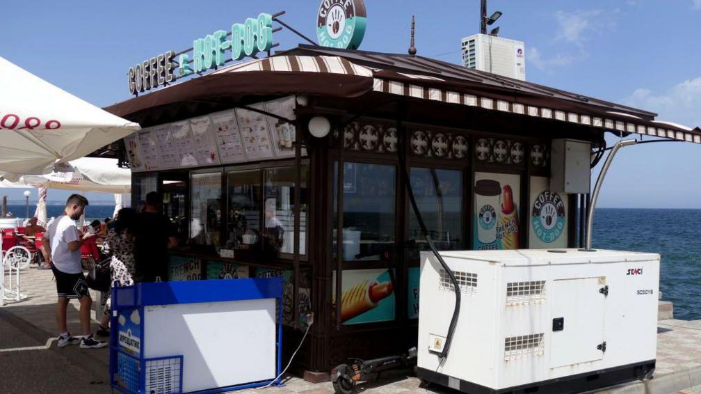 Ice cream kiosk on Odesa seafront with generator