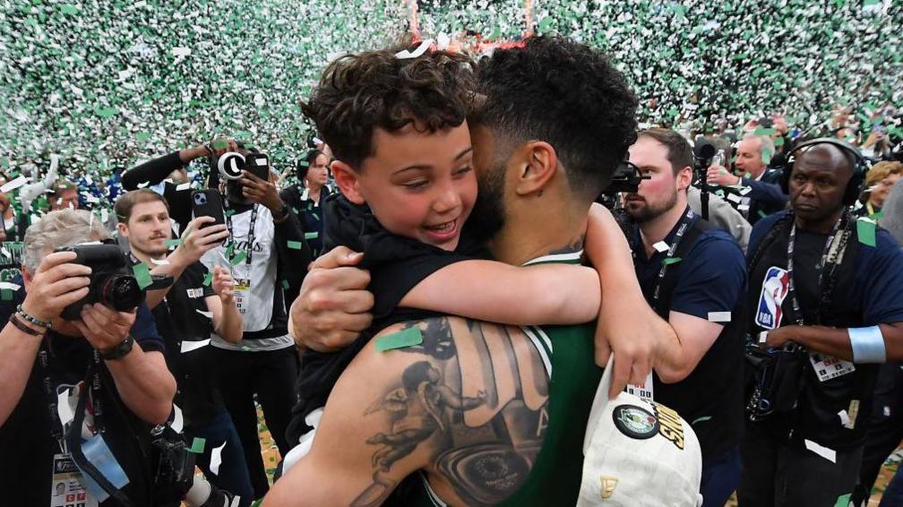 Jayson “Deuce” Tatum Jr. hugging his dad Jayson Tatum