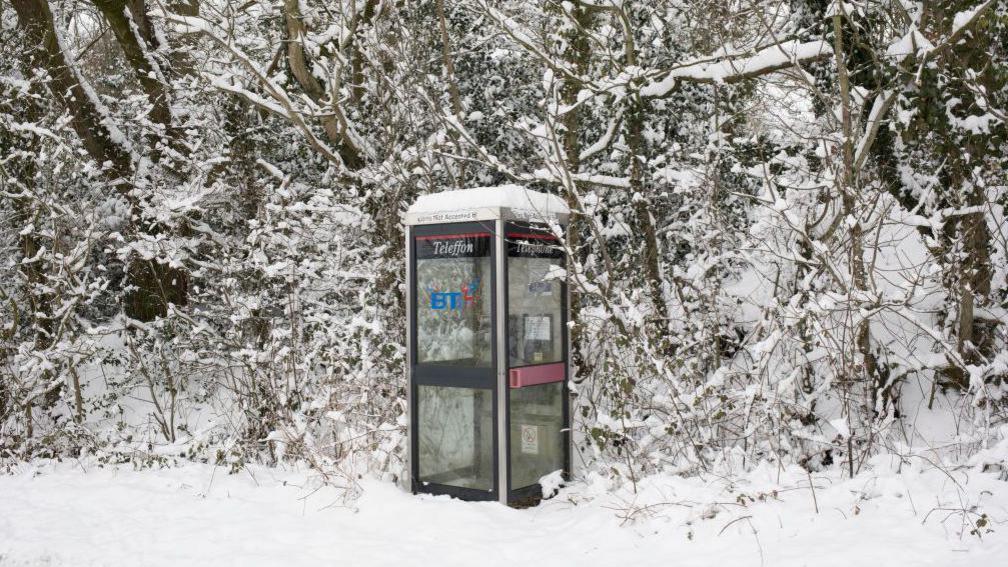 kx100 phone box in the snow