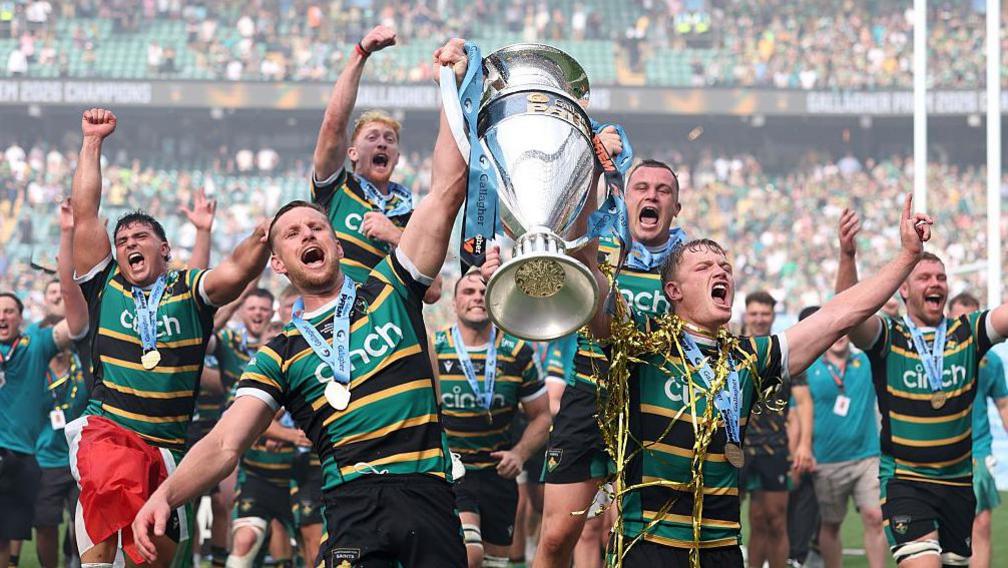 Fraser Dingwall and Fin Smith lift the Prem Rugby trophy following Northampton's win over Exeter