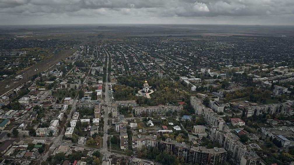 A general aerial view shows the destroyed city covered in morning fog, following months of intense fighting near the front line, on October 7, 2025 in Pokrovsk