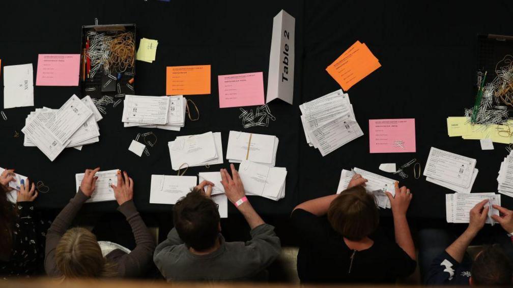 Members of staff count ballots at the Westmorland and Lonsdale constituency counting centre in Kendal, north west England, on June 8, 2017.