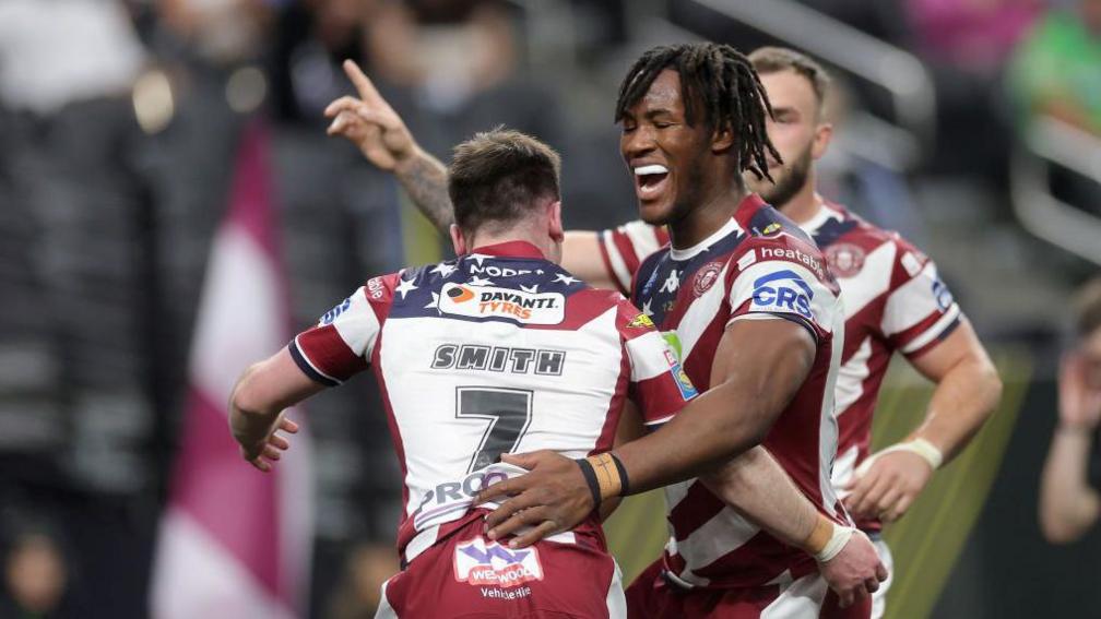 Wigan's Junior Nsemba congratulates Harry Smith following his try against Warrington