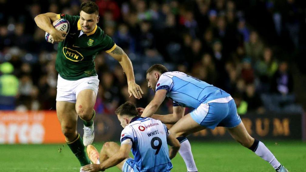 Andre Esterhuizen carries the ball against Scotland