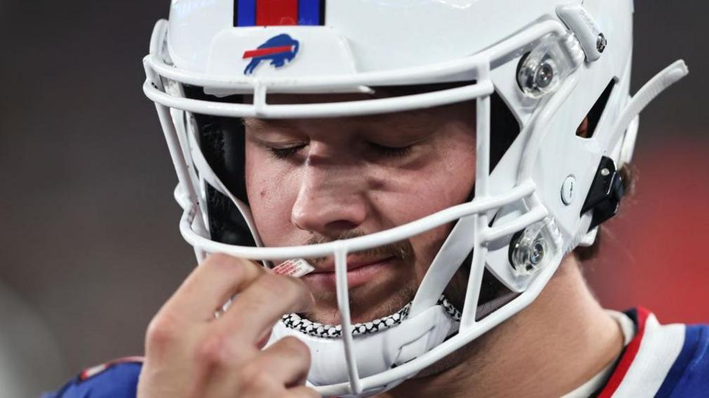 Buffalo Bills quarterback Josh Allen uses smelling salts during a game in 2023