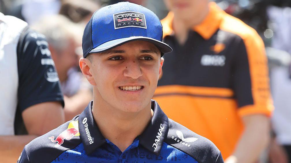 Isack Hadjar walking on the Formula 1 grid