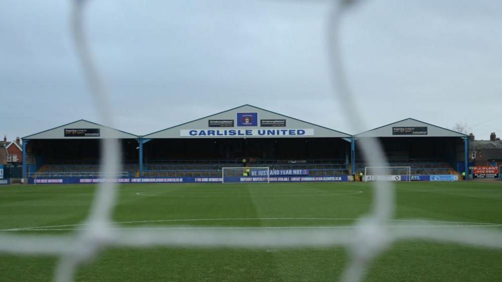 A view of the Warwick Road end at Carlisle's Brunton Park from behind the goal at the other end