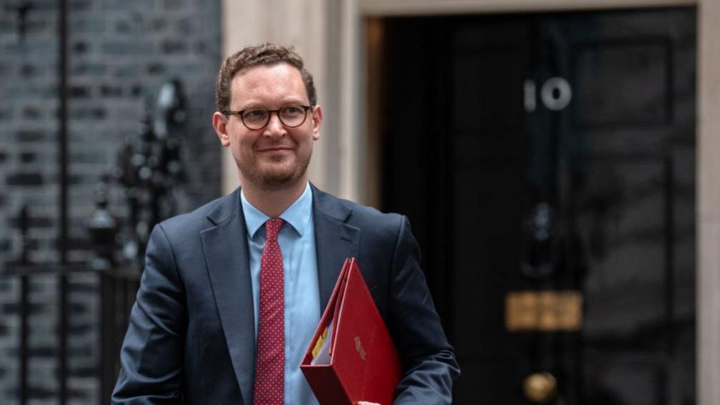 Darren Jones in Downing Street, with the No 10 door behind him