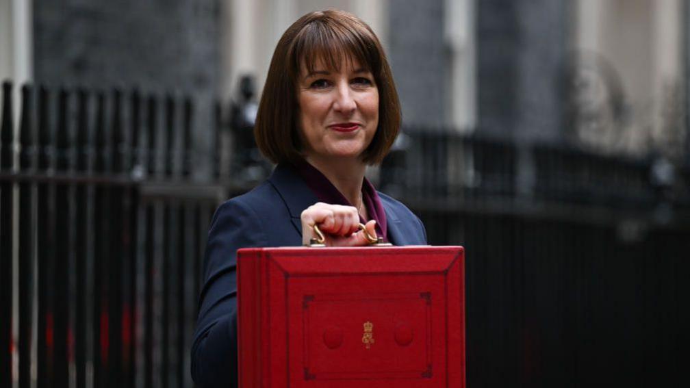 Chancellor Rachel Reeves holds up the ministerial red box for the Chancellors office before the 2024 budget. 