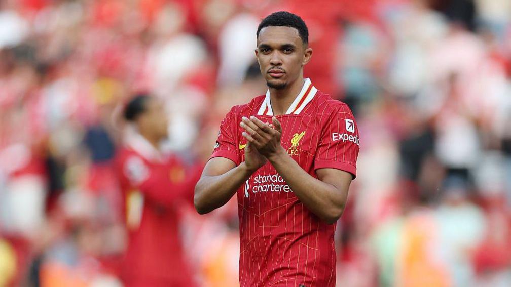 Trent Alexander Arnold applauds in front of fans at Anfield