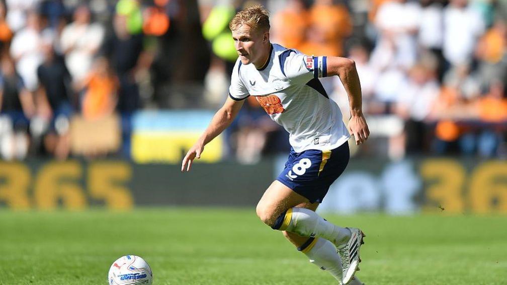 Ali McCann drives forward with the ball for Preston North End against Wolverhampton Wanderers