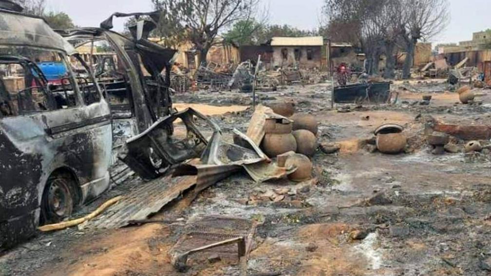 This picture taken on 1 September 2023 shows a view of destruction - including burned out cars - in a livestock market area in al-Fasher, the capital of Sudan's North Darfur state. 