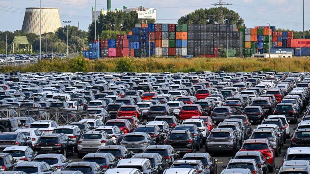 New cars of various brands are parked for export on the parking of a car terminal at the harbour of Duisburg, western Germany