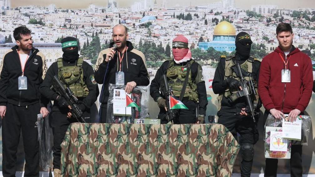 Sagui Dekel-Chen (left), Yair Horn (speaking, centre) and Sasha Troufanov (right) during their release by Hamas in Khan Younis, 15 February 