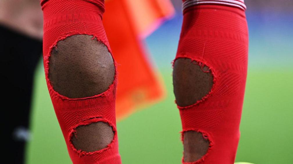 Noni Madueke with holes in the back of his socks