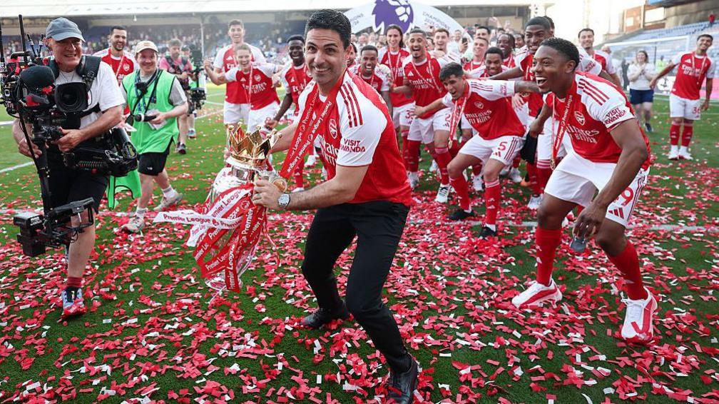 Mikel Arteta celebrates winning the Premier League title with his players