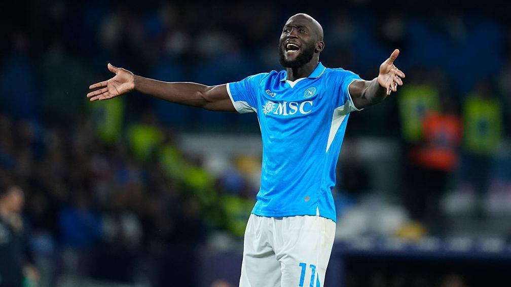 Romelu Lukaku gestures while wearing a Napoli home shirt