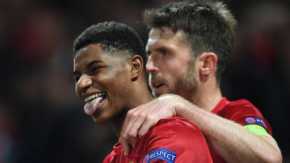 Marcus Rashford of Manchester United celebrates with team mate Michael Carrick
