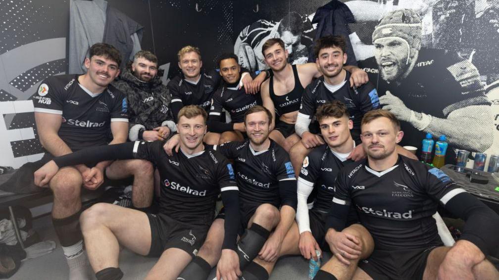 Newcastle Falcons players smiling in the dressing room after beating Sale Sharks in the Premiership Rugby Cup