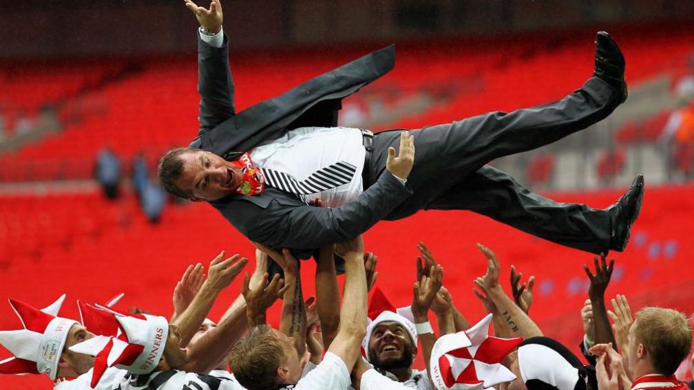 Brendan Rodgers being thrown into the air by Swansea players after beating Reading in the play-off final