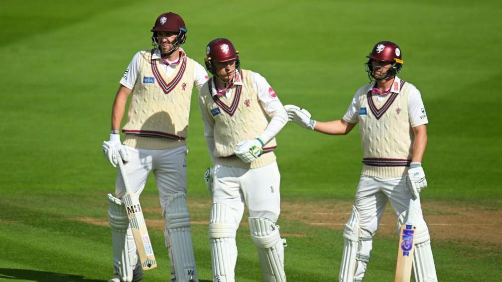 Craig Overton, Tom Banton and runner Tom Lammondby batting for Somerset in the 2024 County Championship