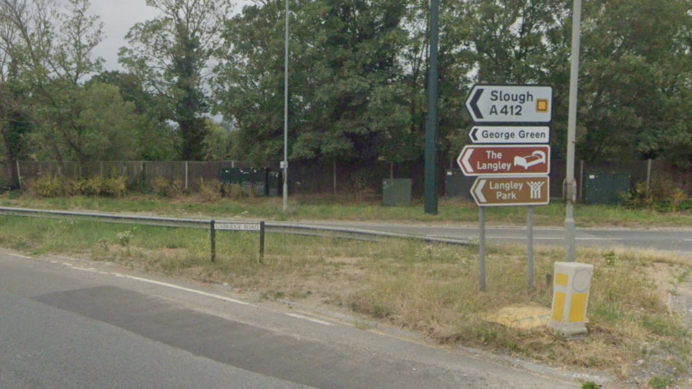 Road signs reading 'Slough', 'George Green' and 'Langley Park' as well as a sign for 'Uxbridge Road'