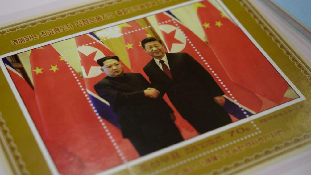 A commemorative stamp featuring North Korean leader Kim Jong Un (L) meeting with China's leader Xi Jinping is pictured at a shop in Pyongyang on June 18, 2019