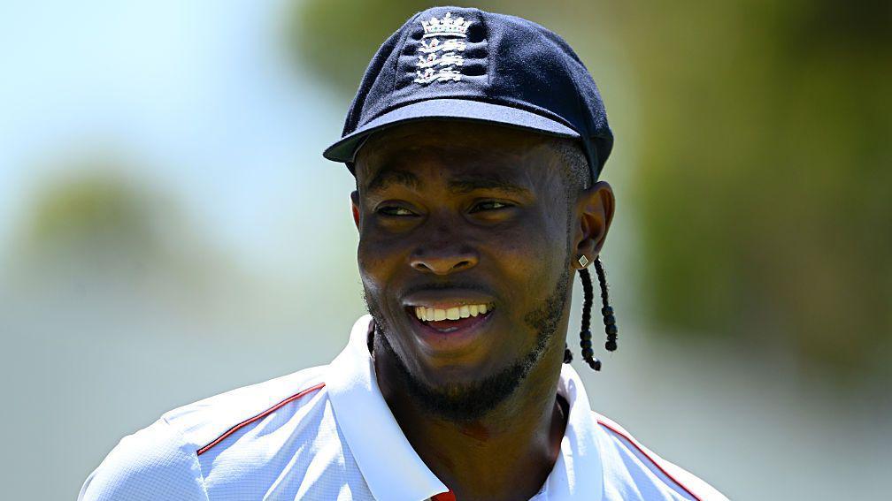 Jofra Archer smiling during an England warm-up at Lilac Hill