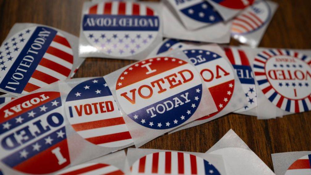 "I voted" stickers sit on a table 