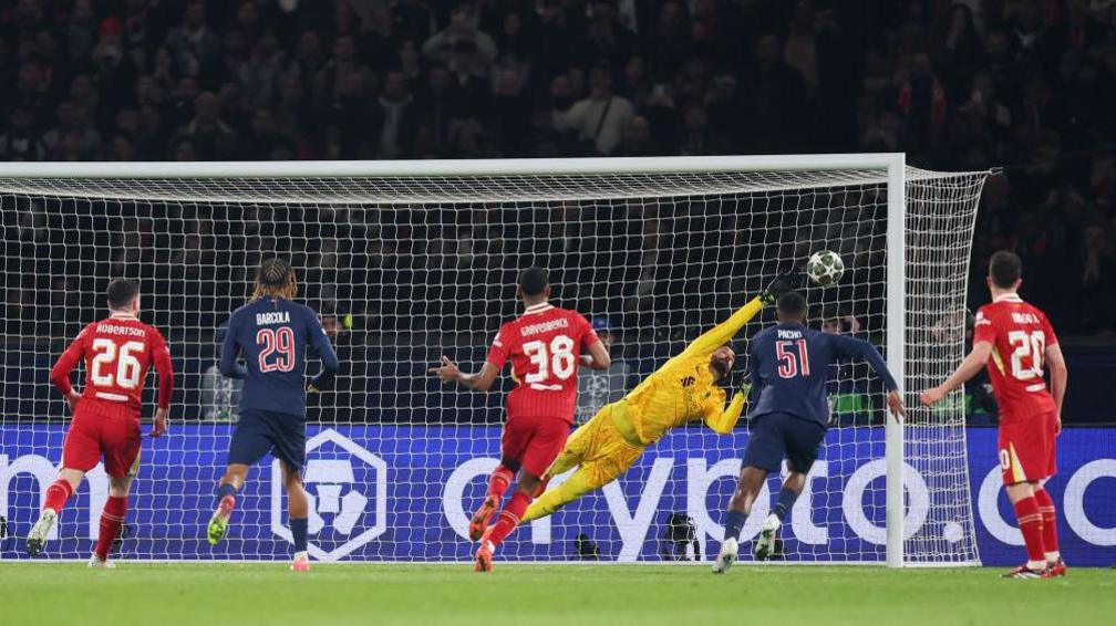 Alisson makes a save against PSG