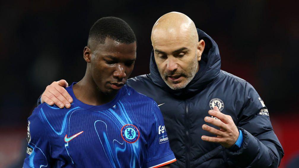 Enzo Maresca, Manager of Chelsea, speaks to Moises Caicedo at the end of the Premier League match between Manchester United FC and Chelsea FC at Old Trafford