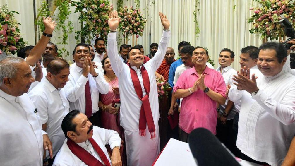 A scion of Sri Lanka's Rajapaksa family, presidential candidate Namal Rajapaksa (C) gestures as he receives ticket from the Sri Lanka Podujana Peramuna (SLPP) party in Colombo on August 7, 2024. 