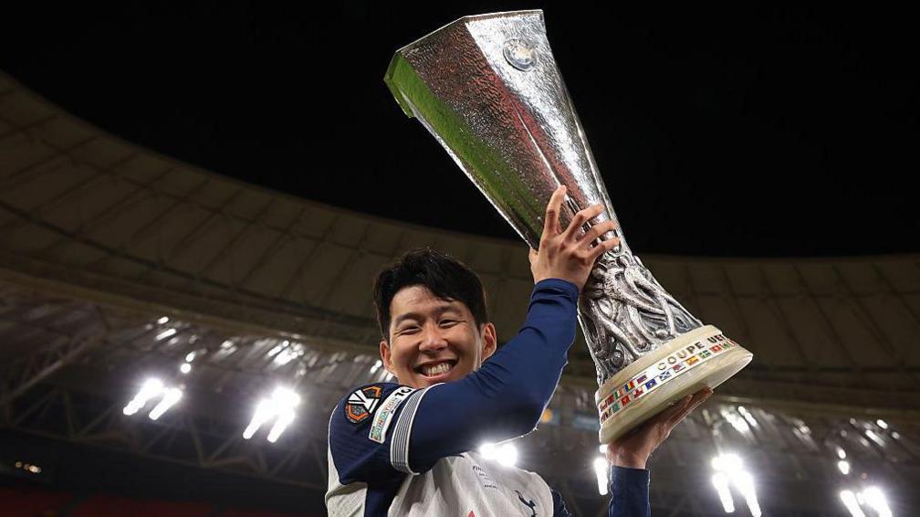Tottenham captain Son Heung-min holds the Europa League trophy after his team's win against Manchester United in Spain