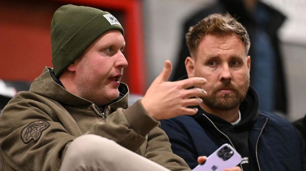 Rob Elliot sitting with Preston Johnson