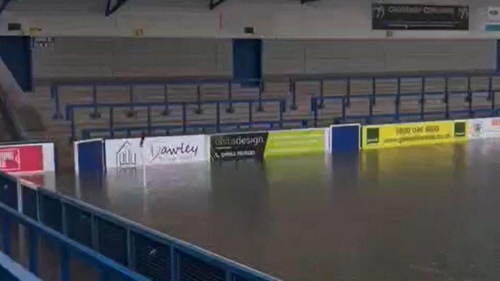 A corner of AFC Telford's stadium, where the pitch is completely covered with water